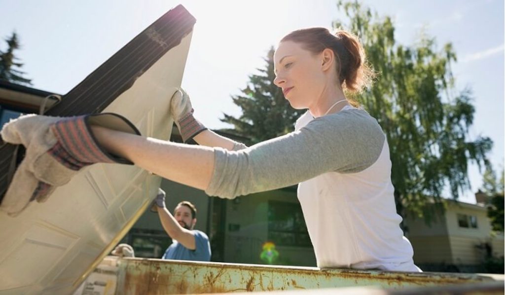 Where can I put a skip? – Woman placing rubbish in a well-placed skip.